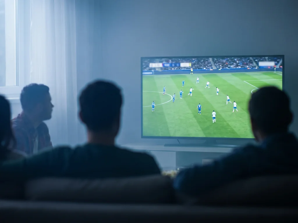 People watching a FIFA World Cup 2026 match on television, illustrating prolonged screen time and eye strain