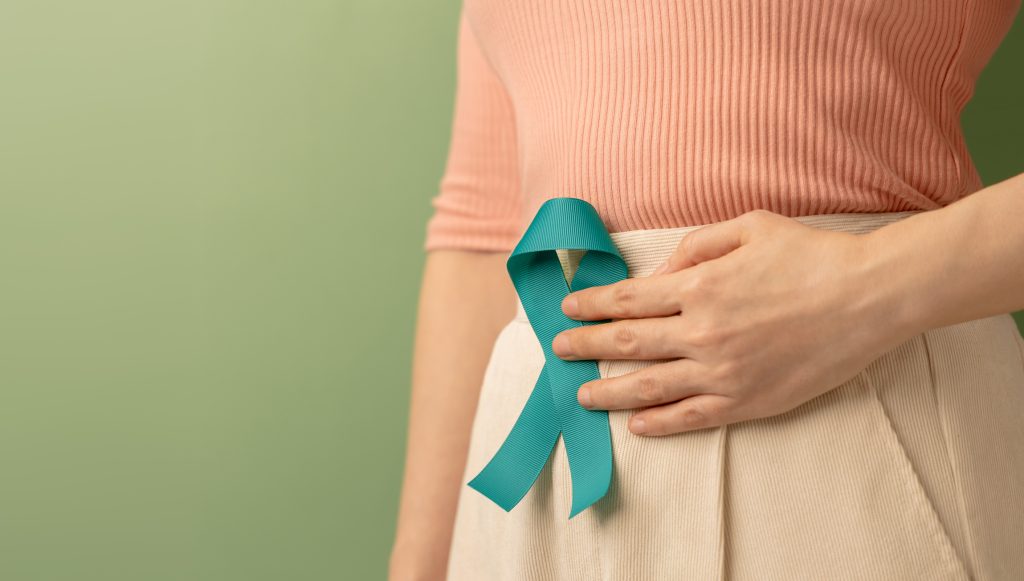 Ovarian and Cervical Cancer Awareness. Woman Holding Teal Ribbon on Lower Abdomen, Uterus, Female Reproductive System, Women's Health, PCOS and Gynecology